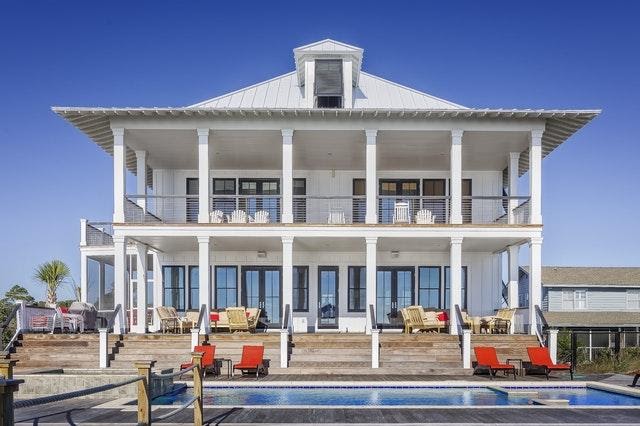 White, Two Story Home With Metal Roof