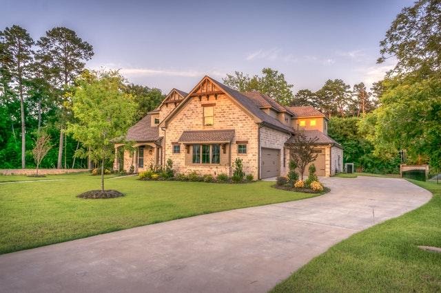 Traditional Brick Home Surround By Grass