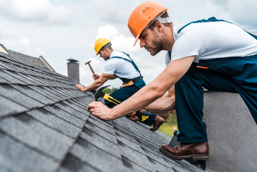 Detail of overlapping roofing tiles on a new build wooden house with dormer windows Detail of overlapping roofing tiles on a new build wooden house with dormer windows