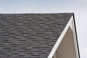 grey and black roof shingles of house on steep sloped roof