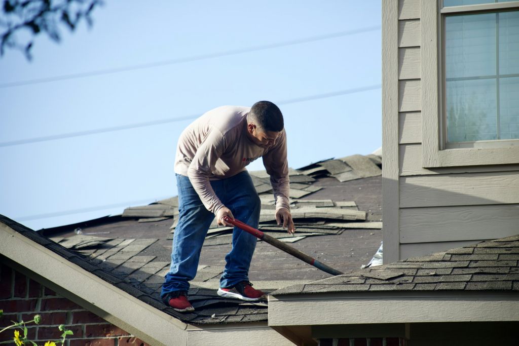 roofing contractor removing damaged roof