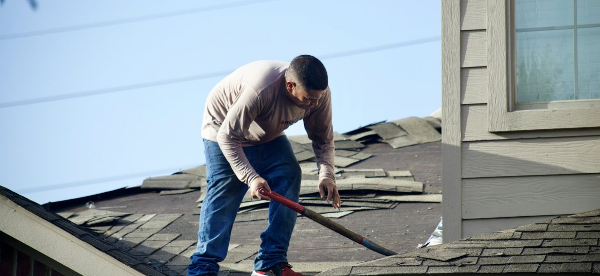 roofing contractor removing damaged roof