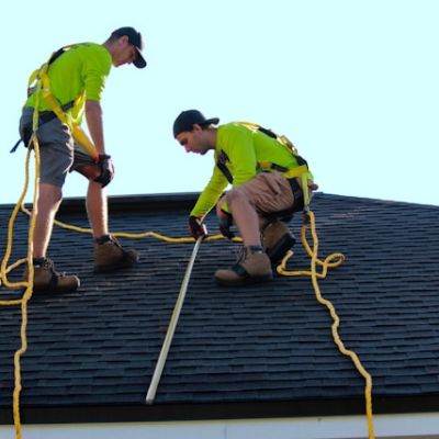 two men installing asphalt roof