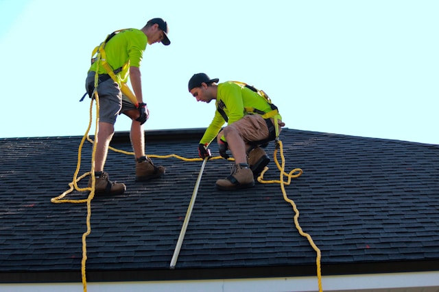 two men installing asphalt roof